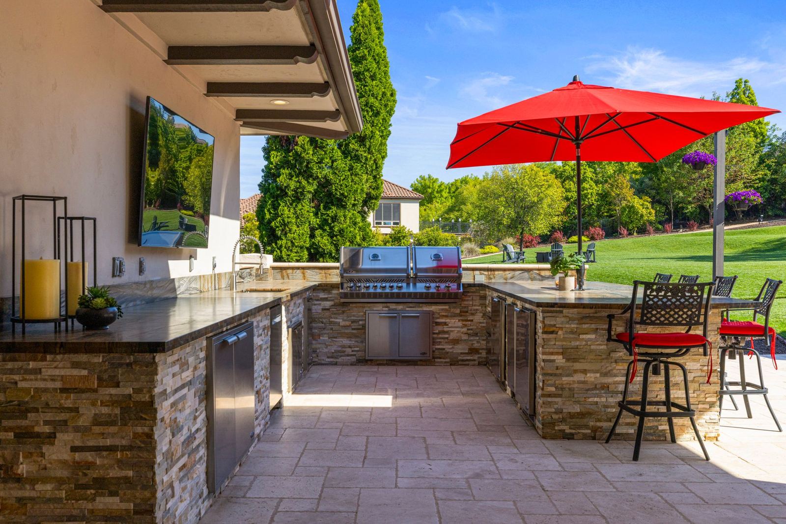 Outdoor kitchen with grill and stone bar