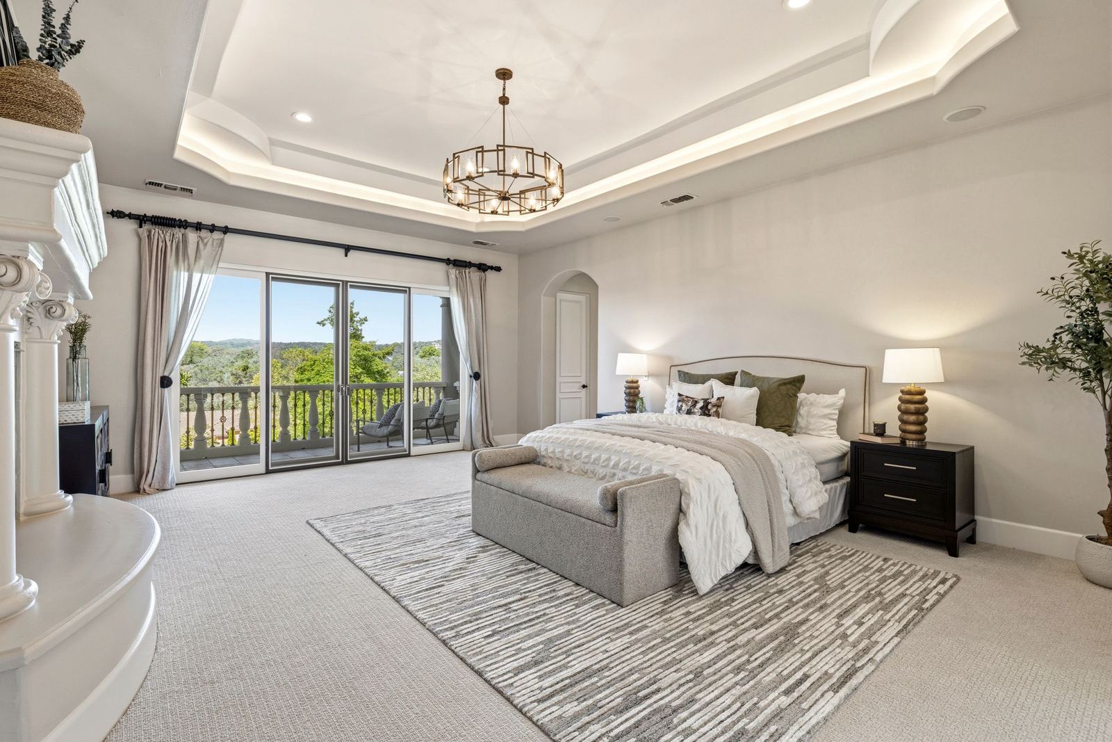 Owner's suite with tray ceiling, chandelier and wall of windows