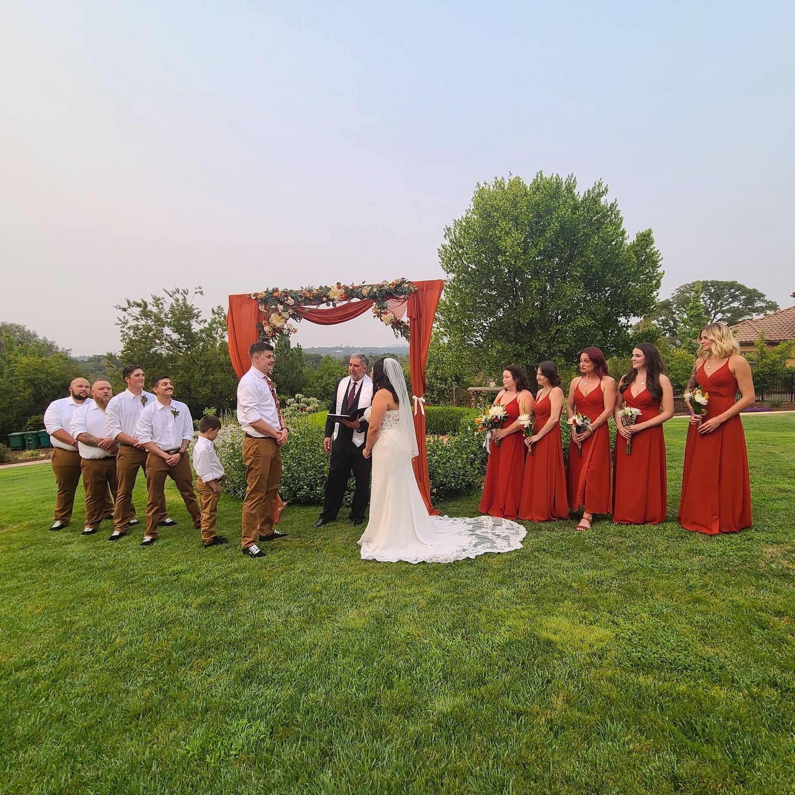 A wedding party standing on the lawn