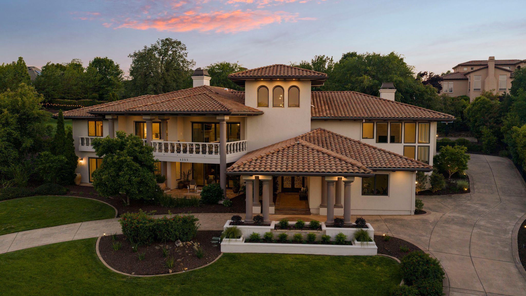The residence at twilight, lit from within